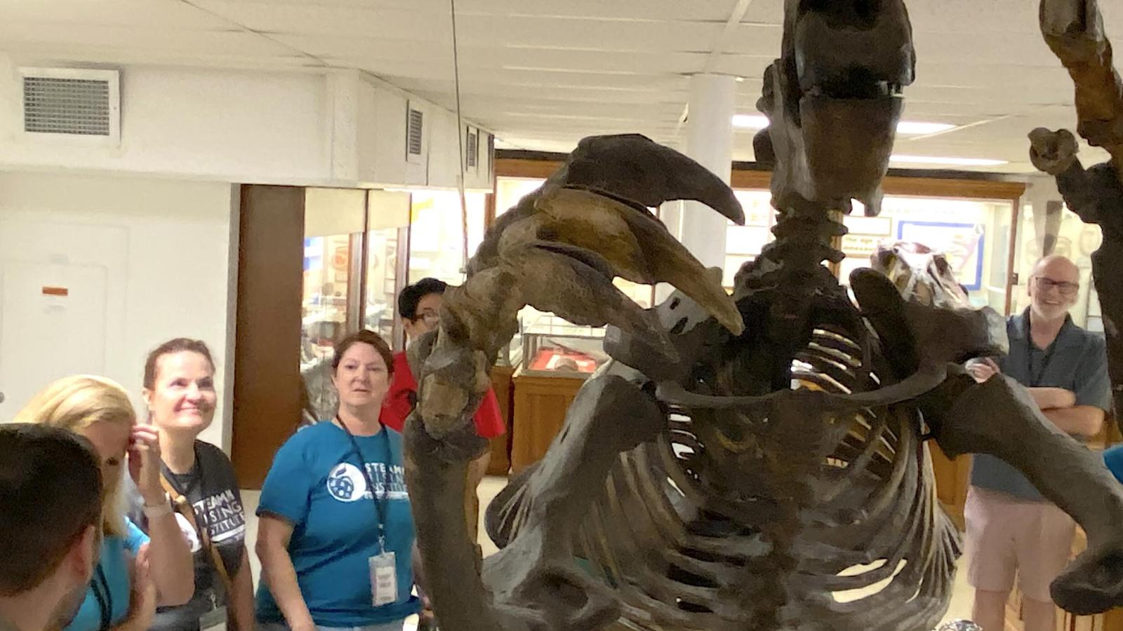 STEAMM Rising - Columbus School teachers study a fossil skeleton